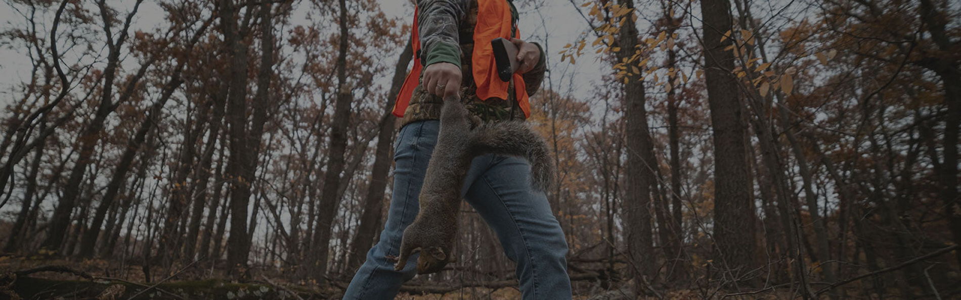 hunter carrying dead squirrel